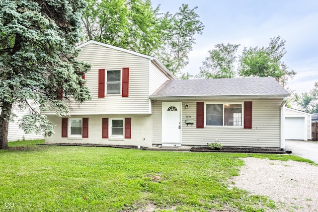 3613 Moller Rd, Indianapolis, IN 46224 - tri-level home featuring an outdoor structure, a front yard, brick siding, and a shingled roof