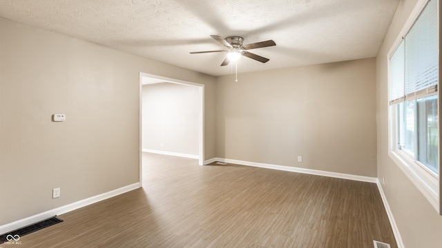 3613 Moller Rd, Indianapolis, IN 46224 - empty room featuring ceiling fan, wood finished floors, and a textured ceiling