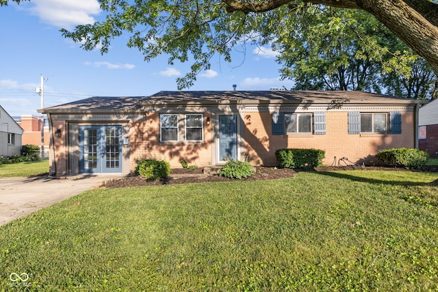 748 Maple Ln, Brownsburg, IN 46112 - ranch-style home featuring brick siding, a front yard, french doors, and driveway