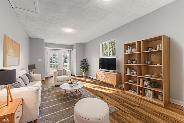 748 Maple Ln, Brownsburg, IN 46112 - living room featuring wood finished floors, a textured ceiling, and french doors