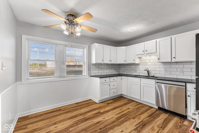 748 Maple Ln, Brownsburg, IN 46112 - kitchen featuring stainless steel dishwasher, ceiling fan, light wood finished floors, dark countertops, and a textured ceiling