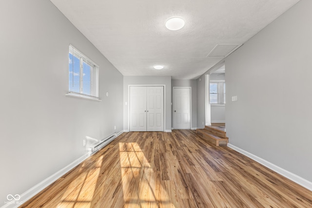 748 Maple Ln, Brownsburg, IN 46112 - below grade area featuring baseboard heating, wood finished floors, and a textured ceiling