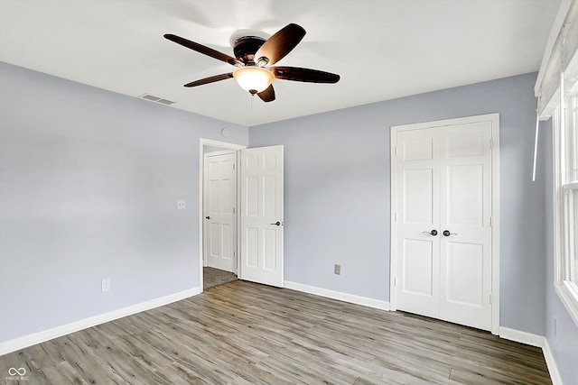 6059 Buck Blvd, Indianapolis, IN 46237 - unfurnished bedroom featuring wood finished floors and ceiling fan