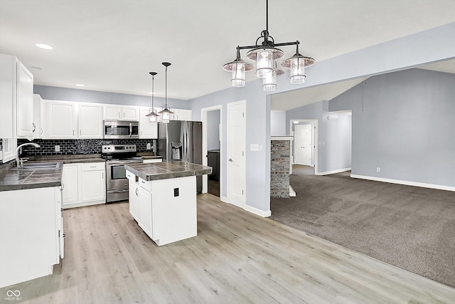 6059 Buck Blvd, Indianapolis, IN 46237 - kitchen with stainless steel appliances, a center island, tasteful backsplash, white cabinetry, and pendant lighting