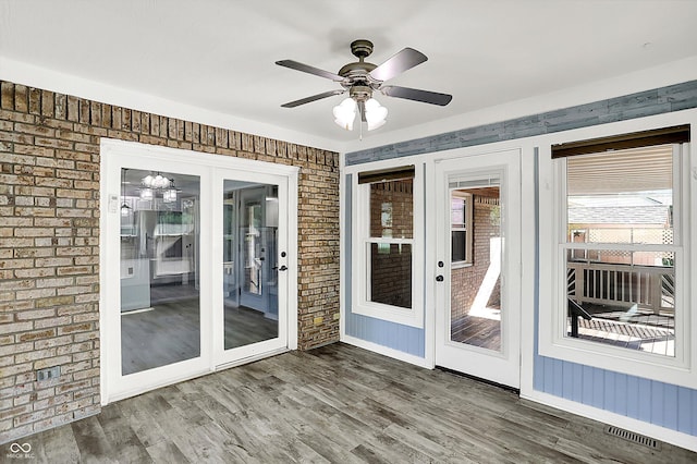 6059 Buck Blvd, Indianapolis, IN 46237 - doorway with brick wall, ceiling fan, and wood finished floors