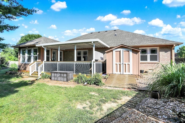 6059 Buck Blvd, Indianapolis, IN 46237 - back of property with a shed, a shingled roof, brick siding, and a yard