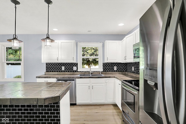 6059 Buck Blvd, Indianapolis, IN 46237 - kitchen featuring stainless steel appliances, light wood-type flooring, white cabinetry, tasteful backsplash, and recessed lighting