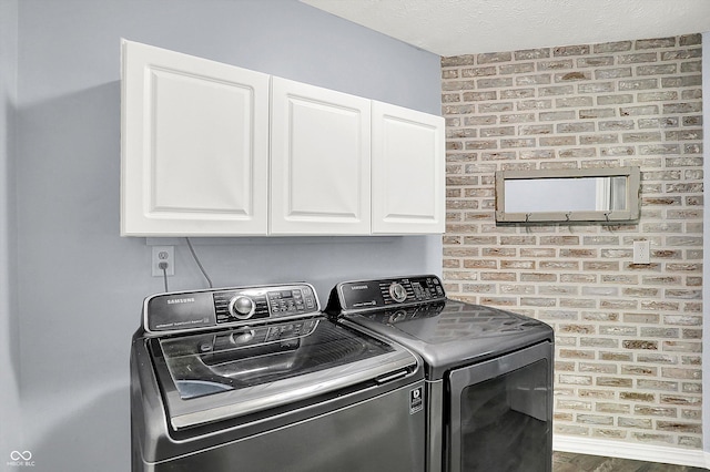 6059 Buck Blvd, Indianapolis, IN 46237 - laundry area featuring washing machine and dryer, cabinet space, and wood finished floors