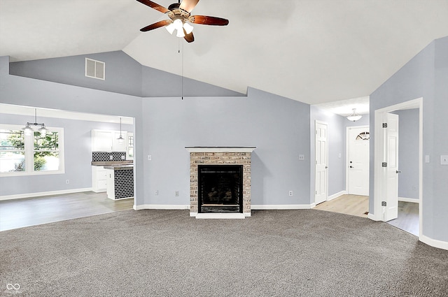 6059 Buck Blvd, Indianapolis, IN 46237 - unfurnished living room featuring carpet flooring, a ceiling fan, a brick fireplace, and high vaulted ceiling