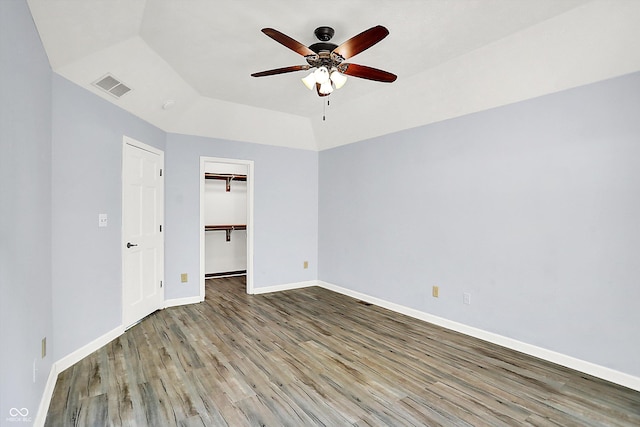 6059 Buck Blvd, Indianapolis, IN 46237 - unfurnished bedroom featuring wood finished floors, a ceiling fan, and a spacious closet