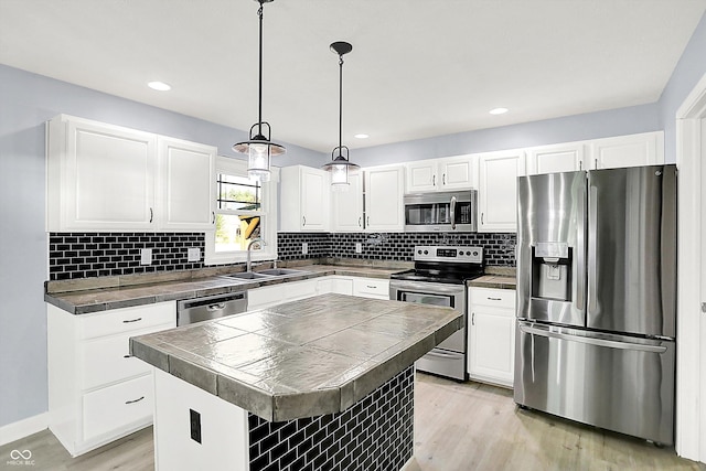 6059 Buck Blvd, Indianapolis, IN 46237 - kitchen with appliances with stainless steel finishes, light wood-style flooring, white cabinets, backsplash, and recessed lighting