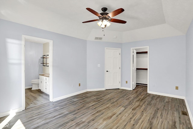 6059 Buck Blvd, Indianapolis, IN 46237 - unfurnished bedroom with light wood-style flooring, ensuite bathroom, a walk in closet, and ceiling fan