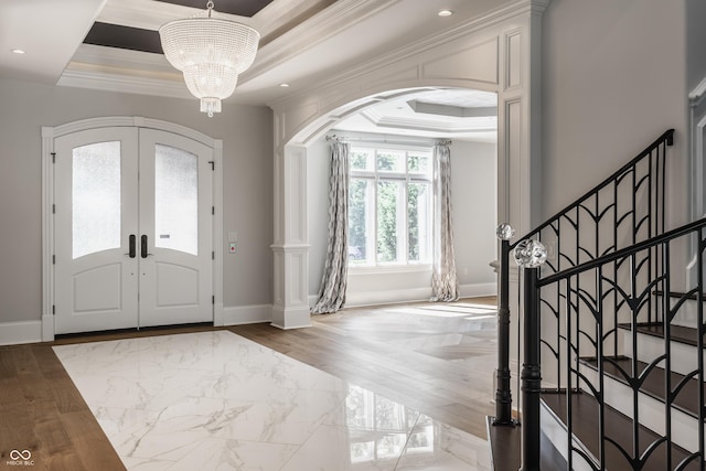 520 Willow Spring Rd, Indianapolis, IN 46240 - entryway featuring a raised ceiling, arched walkways, french doors, crown molding, and a chandelier