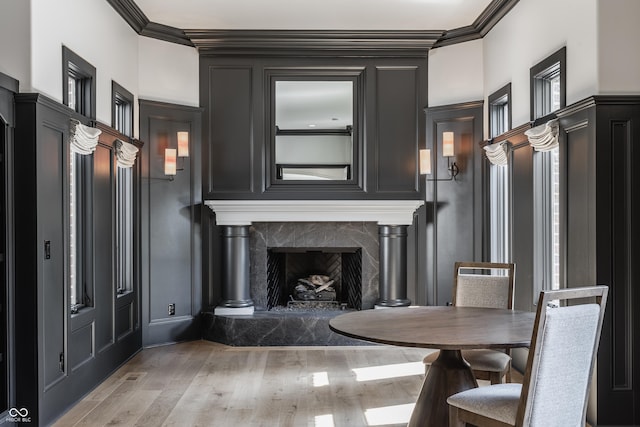 520 Willow Spring Rd, Indianapolis, IN 46240 - dining area with ornamental molding, light wood-style floors, a decorative wall, and a high end fireplace