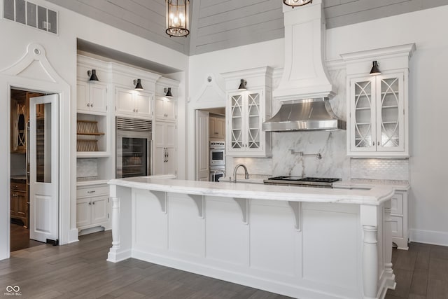 520 Willow Spring Rd, Indianapolis, IN 46240 - kitchen featuring custom range hood, wine cooler, white cabinets, and decorative backsplash