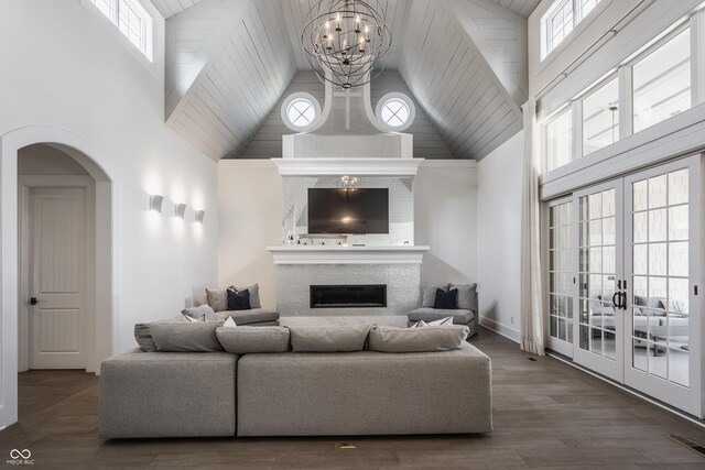 520 Willow Spring Rd, Indianapolis, IN 46240 - living area featuring high vaulted ceiling, a chandelier, arched walkways, a glass covered fireplace, and french doors