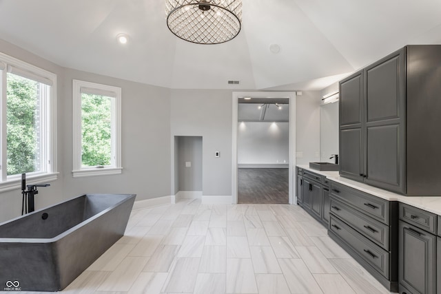 520 Willow Spring Rd, Indianapolis, IN 46240 - kitchen featuring gray cabinetry, healthy amount of natural light, light countertops, and high vaulted ceiling