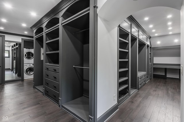 520 Willow Spring Rd, Indianapolis, IN 46240 - spacious closet with stacked washer / drying machine, dark wood finished floors, and arched walkways