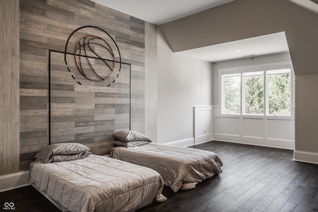 520 Willow Spring Rd, Indianapolis, IN 46240 - bedroom featuring an accent wall, dark wood-style flooring, wood walls, and vaulted ceiling