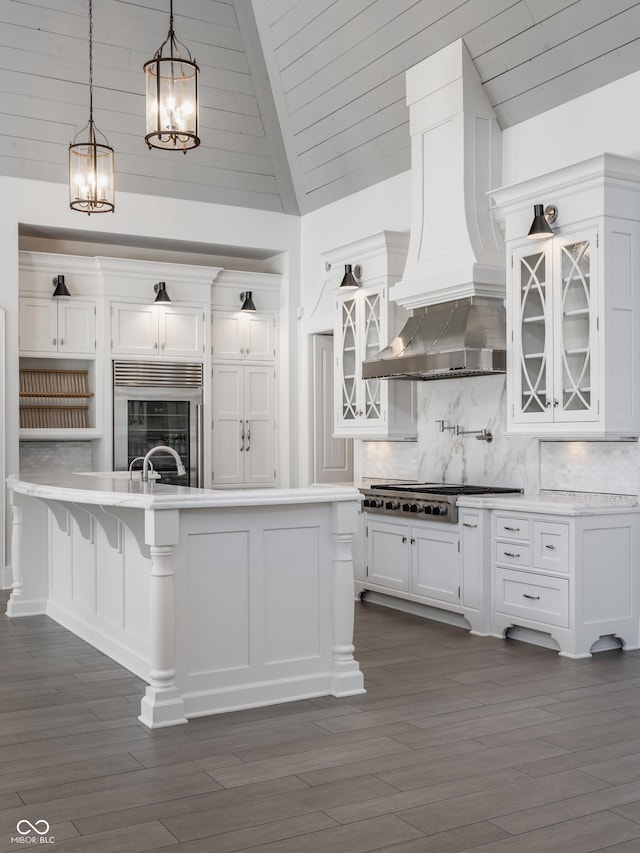 520 Willow Spring Rd, Indianapolis, IN 46240 - kitchen featuring white cabinetry, light countertops, glass insert cabinets, a chandelier, and lofted ceiling