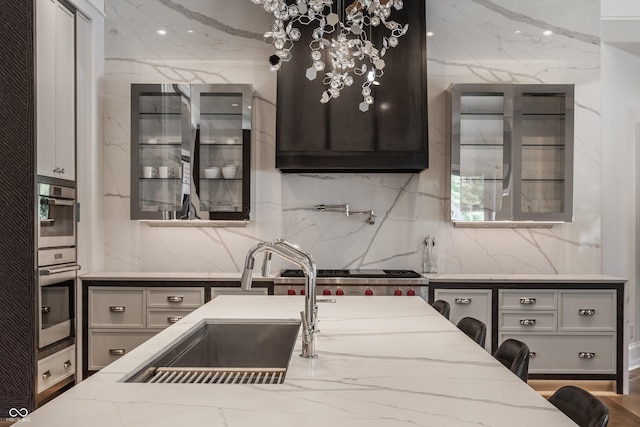 520 Willow Spring Rd, Indianapolis, IN 46240 - kitchen with light stone counters, stainless steel double oven, and tasteful backsplash