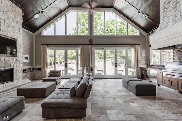 520 Willow Spring Rd, Indianapolis, IN 46240 - living room featuring french doors, high vaulted ceiling, stone tile floors, wooden ceiling, and a fireplace
