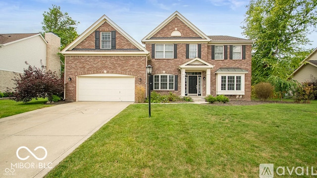 12817 Mojave Dr, Fishers, IN 46037 - view of front of home featuring driveway, a front yard, brick siding, and an attached garage