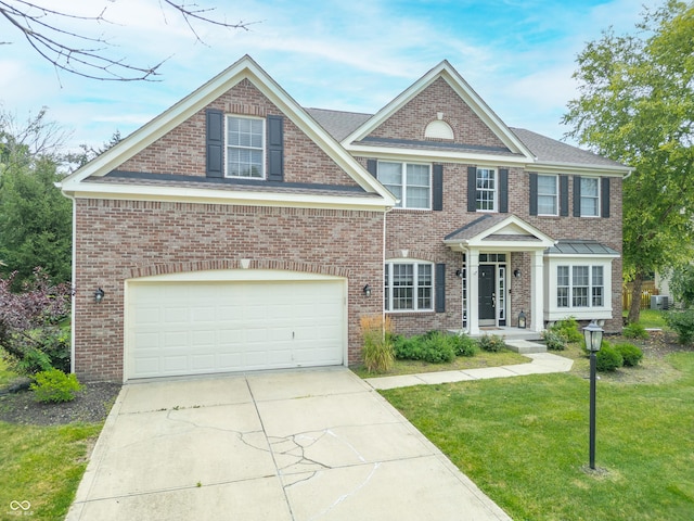 12817 Mojave Dr, Fishers, IN 46037 - view of front of house with driveway, a front yard, and brick siding