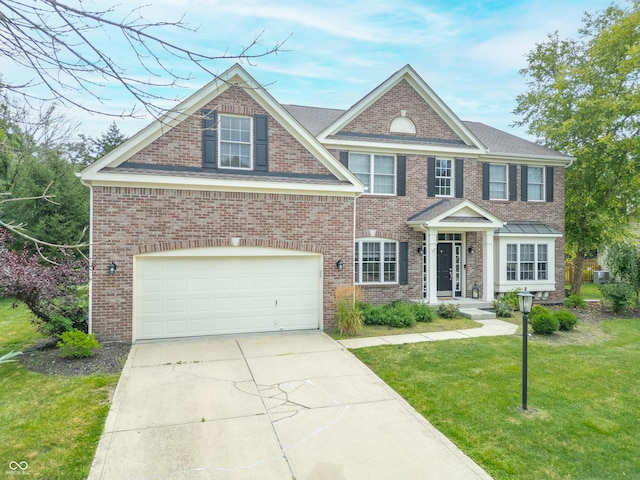 12817 Mojave Dr, Fishers, IN 46037 - view of front of property featuring a front lawn, concrete driveway, a garage, and brick siding