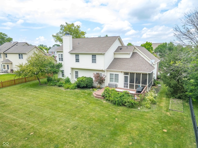 12817 Mojave Dr, Fishers, IN 46037 - rear view of property featuring a shingled roof, a chimney, a sunroom, and a wooden deck