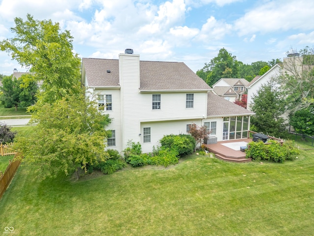 12817 Mojave Dr, Fishers, IN 46037 - back of property featuring a deck, a chimney, a shingled roof, and a sunroom