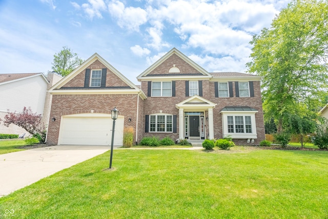 12817 Mojave Dr, Fishers, IN 46037 - colonial home with a front lawn, concrete driveway, and brick siding