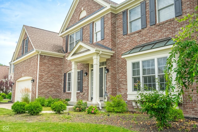 12817 Mojave Dr, Fishers, IN 46037 - view of front of house with a garage, brick siding, and roof with shingles