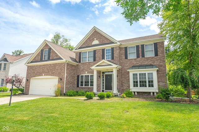 12817 Mojave Dr, Fishers, IN 46037 - colonial house featuring brick siding, concrete driveway, a front lawn, and a garage