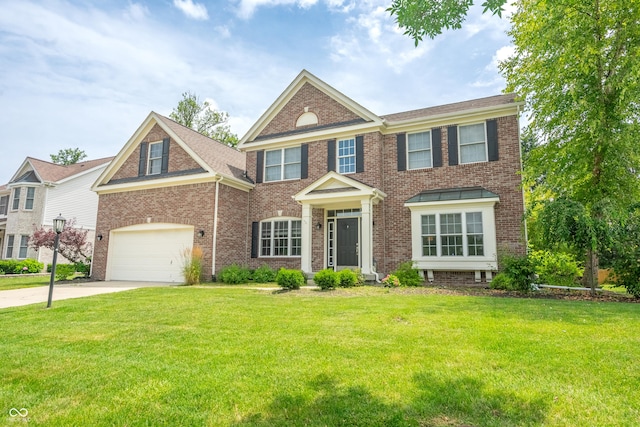 12817 Mojave Dr, Fishers, IN 46037 - colonial inspired home featuring driveway, brick siding, a front lawn, and an attached garage