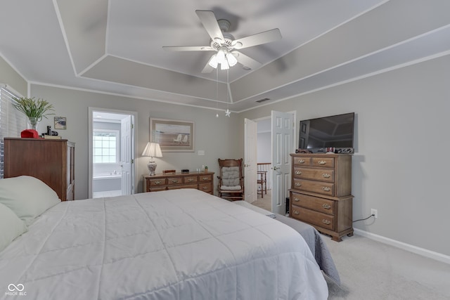 860 Old Eagle Way, Greenwood, IN 46143 - carpeted bedroom with a tray ceiling, connected bathroom, and a ceiling fan
