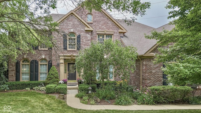 860 Old Eagle Way, Greenwood, IN 46143 - view of front facade featuring brick siding, a shingled roof, and a front lawn