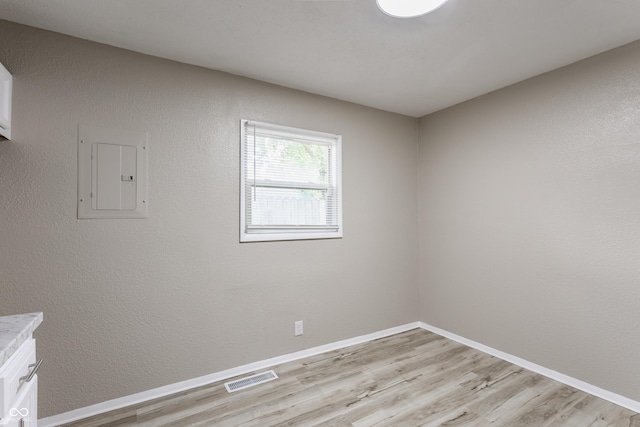 4880 N Katherine Dr, Indianapolis, IN 46226 - spare room featuring electric panel and light wood finished floors