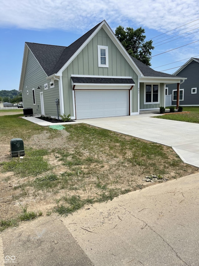 842 E Nutter St, Martinsville, IN 46151 - view of front of home with driveway, board and batten siding, a shingled roof, and a garage