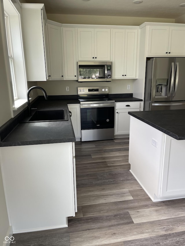 842 E Nutter St, Martinsville, IN 46151 - kitchen featuring stainless steel appliances, dark countertops, white cabinetry, and dark wood finished floors