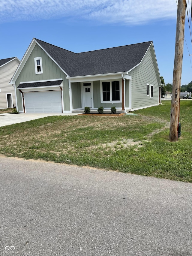 842 E Nutter St, Martinsville, IN 46151 - view of front facade featuring roof with shingles, board and batten siding, concrete driveway, and a front yard