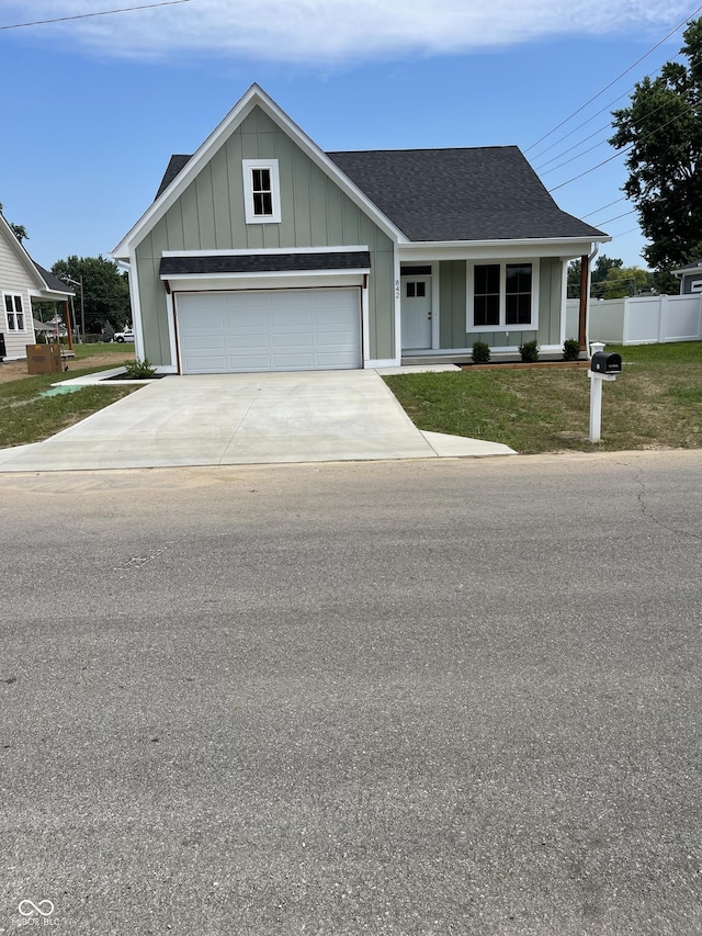 842 E Nutter St, Martinsville, IN 46151 - view of front of property featuring board and batten siding, driveway, a shingled roof, and an attached garage