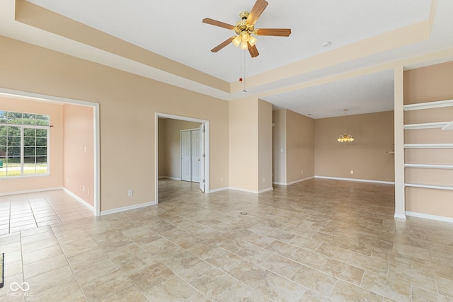 2815 Grandview Ln, Greenwood, IN 46143 - spare room with a raised ceiling, ceiling fan, and a chandelier