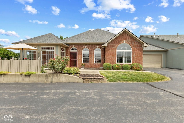 2815 Grandview Ln, Greenwood, IN 46143 - view of front facade featuring brick siding, roof with shingles, asphalt driveway, and an attached garage