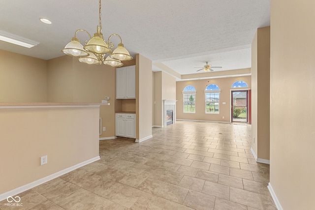 2815 Grandview Ln, Greenwood, IN 46143 - unfurnished room with a chandelier, ceiling fan, a glass covered fireplace, and a textured ceiling