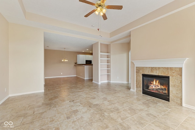 2815 Grandview Ln, Greenwood, IN 46143 - unfurnished living room with a tile fireplace, ceiling fan, and a raised ceiling