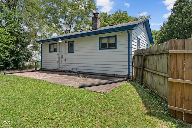 3408 Harvest Ave, Indianapolis, IN 46226 - rear view of house featuring a chimney and a patio area