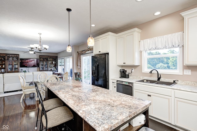4297 W Division Rd, Crawfordsville, IN 47933 - kitchen featuring black refrigerator with ice dispenser, dishwasher, a chandelier, open floor plan, and a breakfast bar area