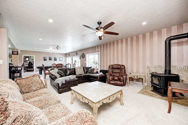 4297 W Division Rd, Crawfordsville, IN 47933 - living room featuring a wood stove, a ceiling fan, carpet, and recessed lighting