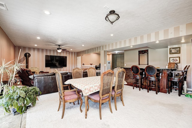 4297 W Division Rd, Crawfordsville, IN 47933 - dining room featuring light colored carpet, bar area, recessed lighting, a ceiling fan, and a wood stove